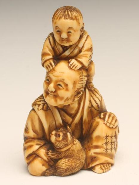 A JAPANESE SMALL ONE PIECE IVORY FIGURE GROUP Image