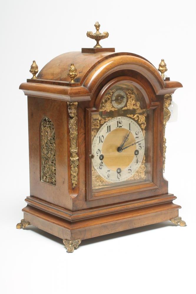 A WALNUT CASED MANTEL CLOCK by Hinde of Whitehaven Image