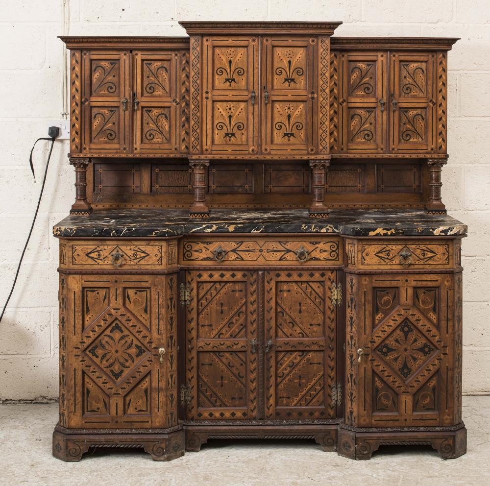 A VICTORIAN AESTHETIC OAK SIDE CABINET of breakfront form with veined black marble top and with Image