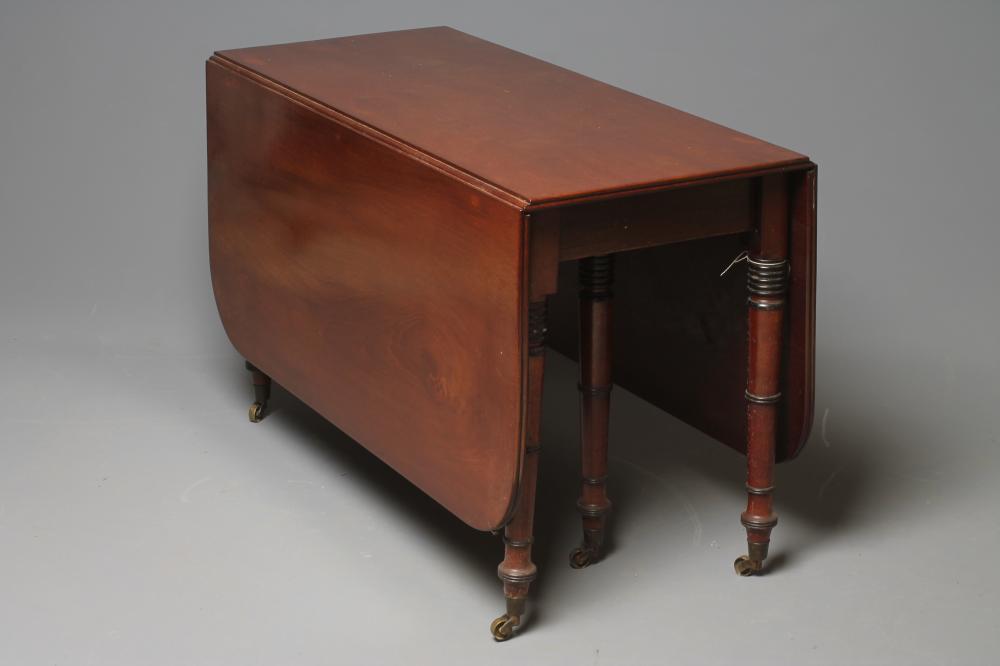 A REGENCY MAHOGANY AND EBONISED DINING TABLE Image