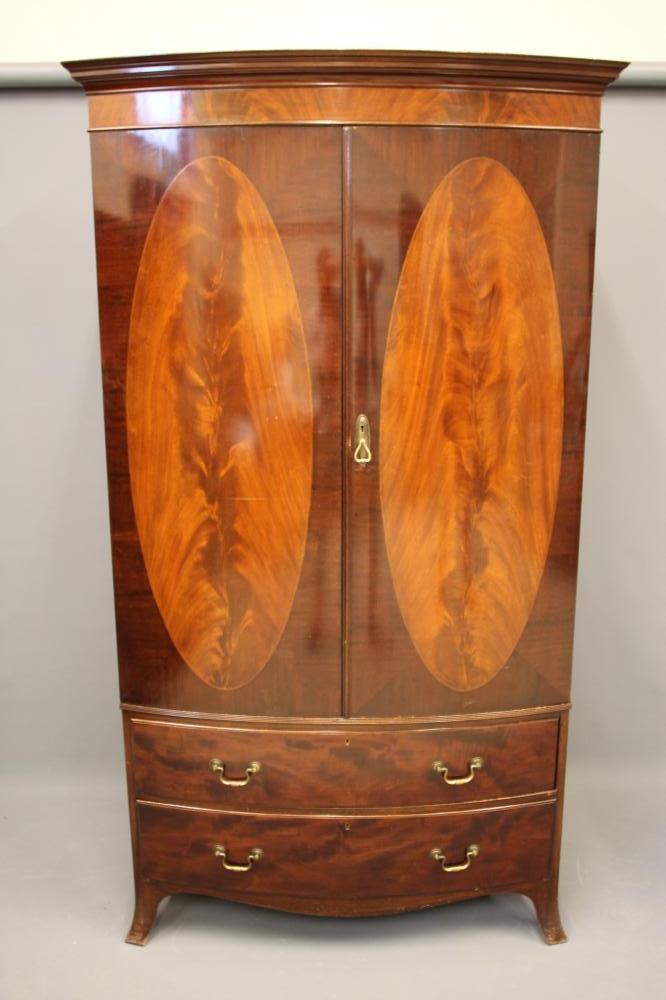 AN EDWARDIAN MAHOGANY BOW FRONT WARDROBE of Georgian design Image