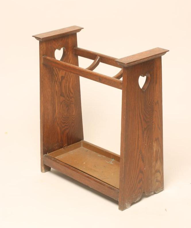 AN ARTS AND CRAFTS OAK STICK STAND of oblong form with dished dividers and lift-out drip tray Image