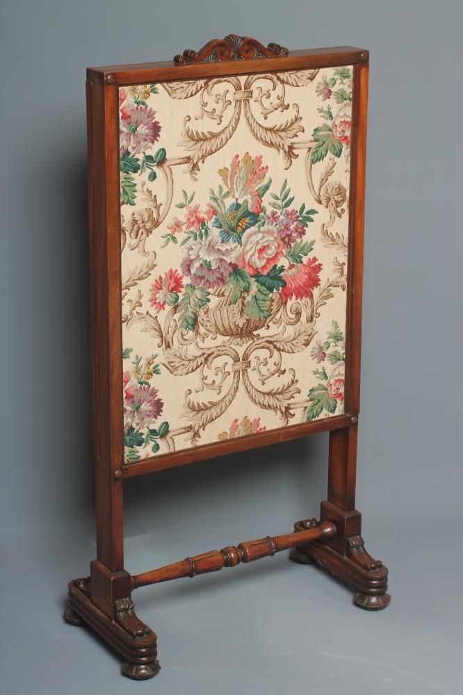 A WILLIAM IV MAHOGANY FRAMED FIRESCREEN of oblong form with two sliding panels now with a floral Image