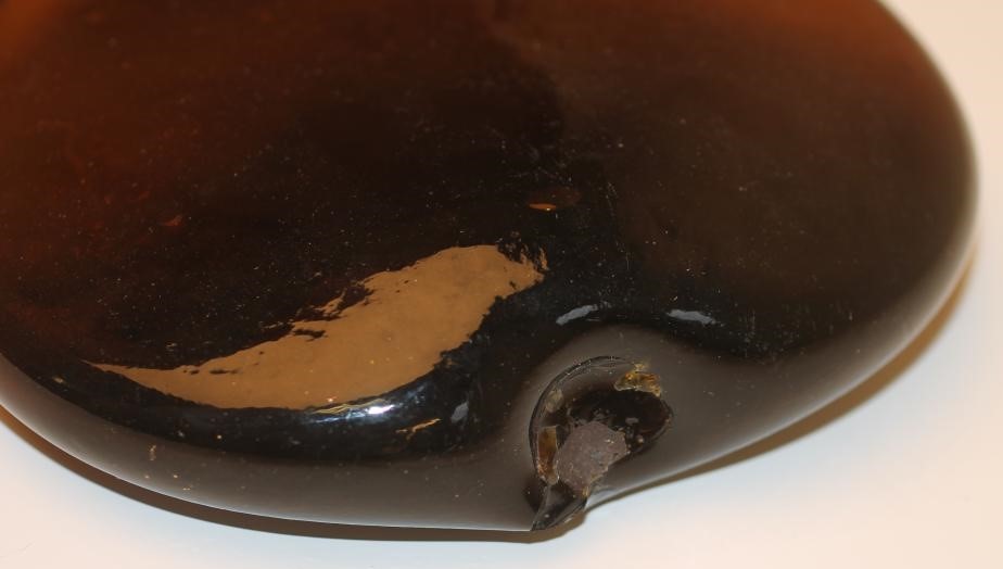 A DARK AMBER GLASS "SADDLE" FLASK Image