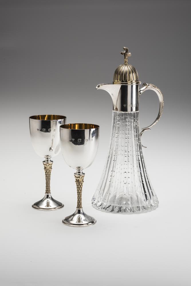 A CLARET JUG AND A PAIR OF MATCHING SILVER GOBLETS Image
