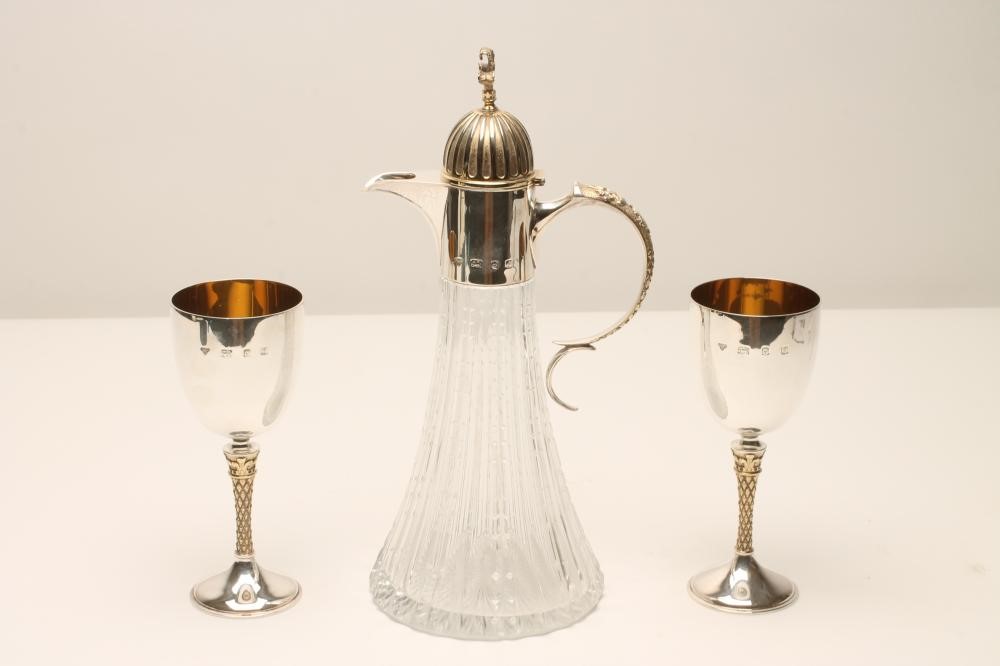 A CLARET JUG AND A PAIR OF MATCHING SILVER GOBLETS Image