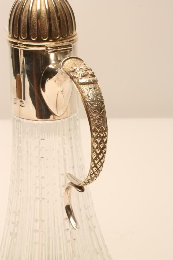 A CLARET JUG AND A PAIR OF MATCHING SILVER GOBLETS Image