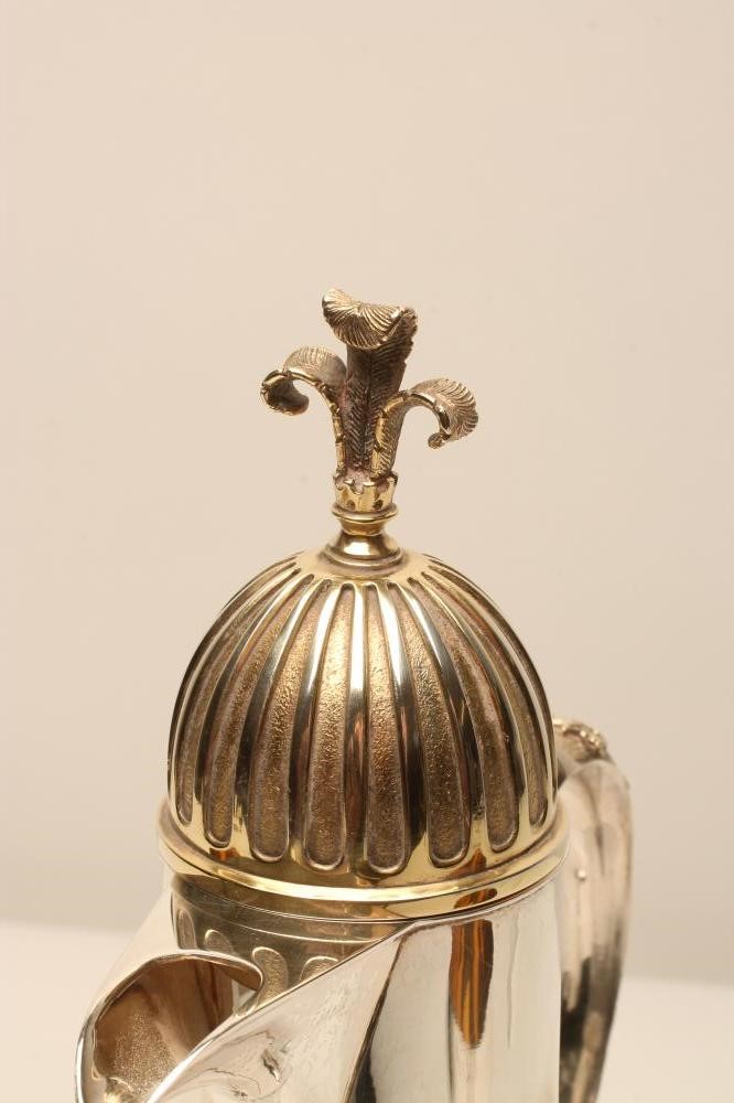 A CLARET JUG AND A PAIR OF MATCHING SILVER GOBLETS Image