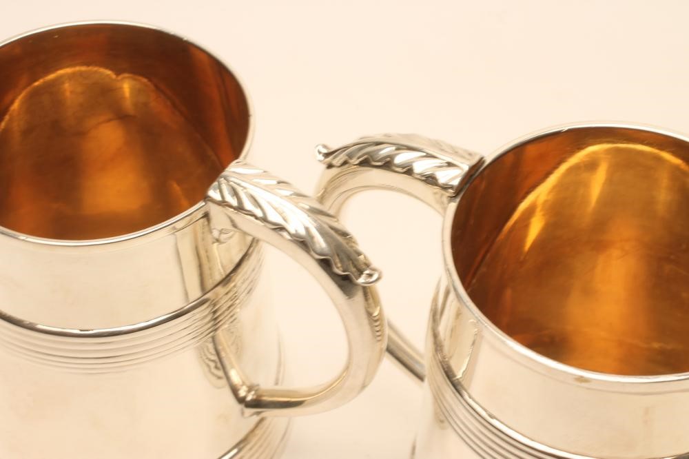 A CLARET JUG AND A PAIR OF MATCHING SILVER GOBLETS Image