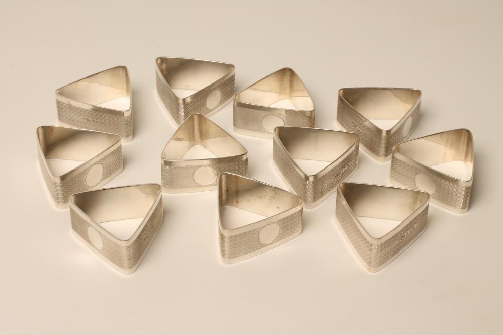 A SET OF TWELVE ART DECO SILVER NAPKIN RINGS Image