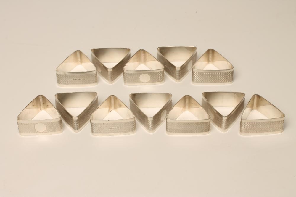 A SET OF TWELVE ART DECO SILVER NAPKIN RINGS Image