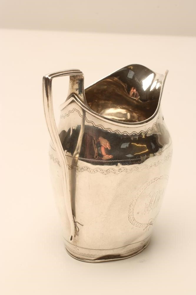 A LATE GEORGE III SILVER MILK JUG Image