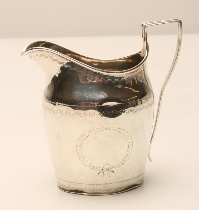 A LATE GEORGE III SILVER MILK JUG Image