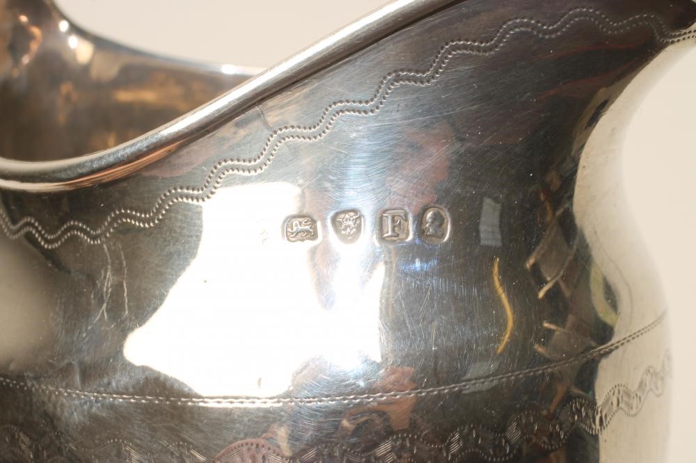 A LATE GEORGE III SILVER MILK JUG Image