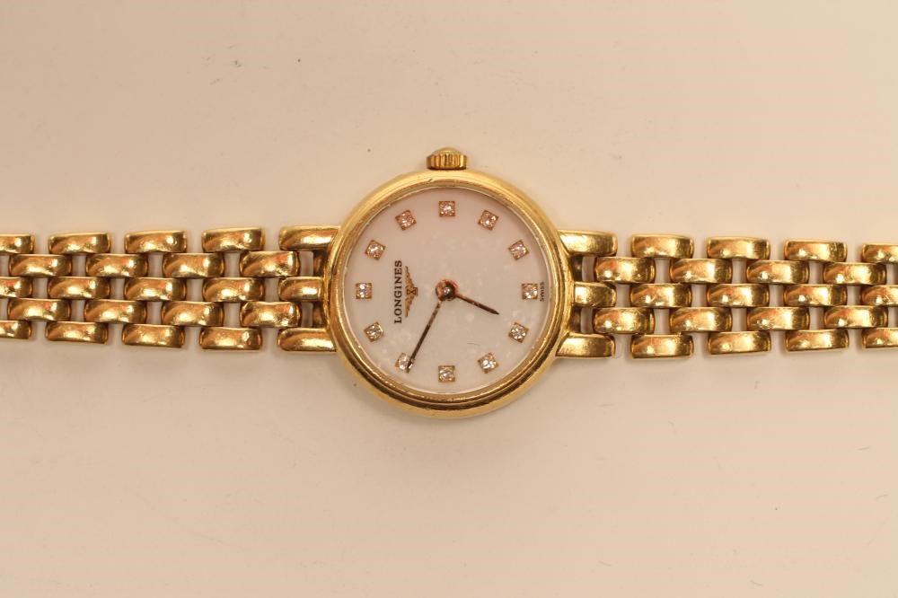 A LADY'S LONGINES 18CT GOLD WRISTWATCH Image