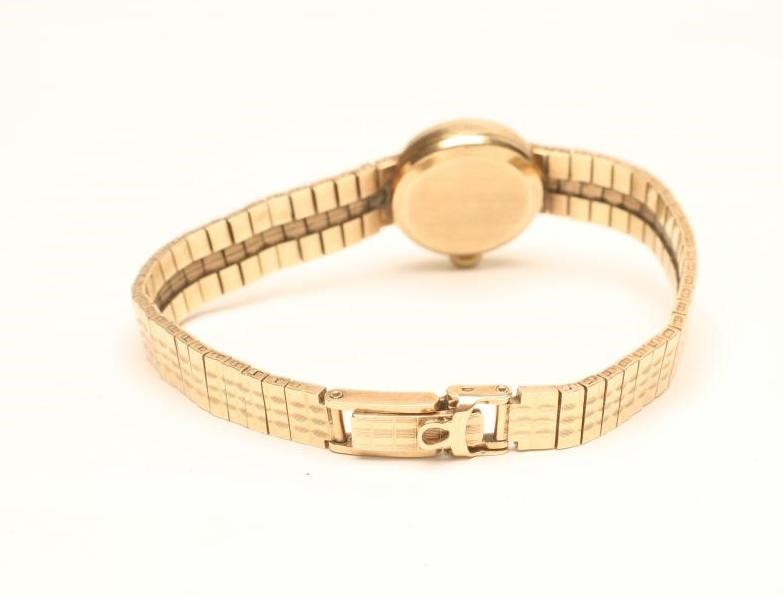 A LADY'S 9CT GOLD OMEGA WRISTWATCH Image