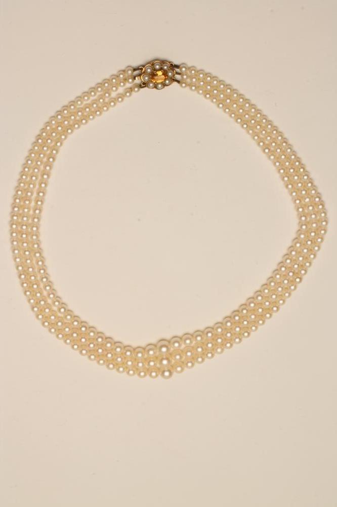 A TRIPLE STRAND CULTURED PEARL NECKLACE Image