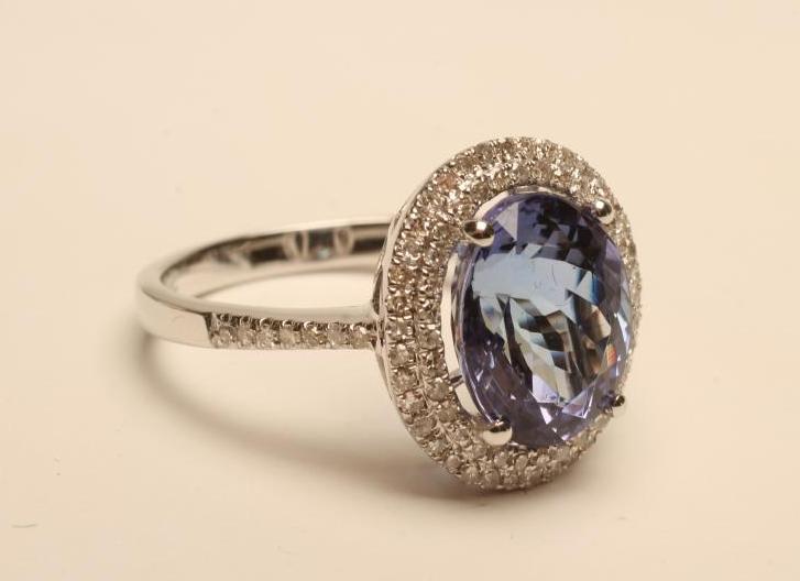 A TANZANITE AND DIAMOND CLUSTER RING Image