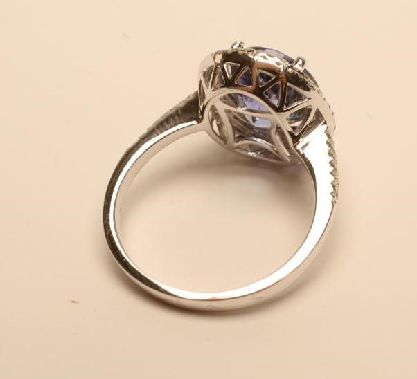 A TANZANITE AND DIAMOND CLUSTER RING Image