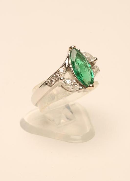 AN EMERALD AND DIAMOND RING Image