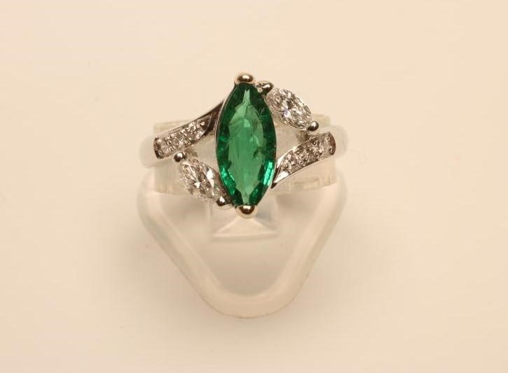 AN EMERALD AND DIAMOND RING Image