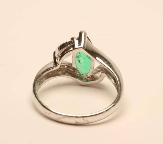 AN EMERALD AND DIAMOND RING Image