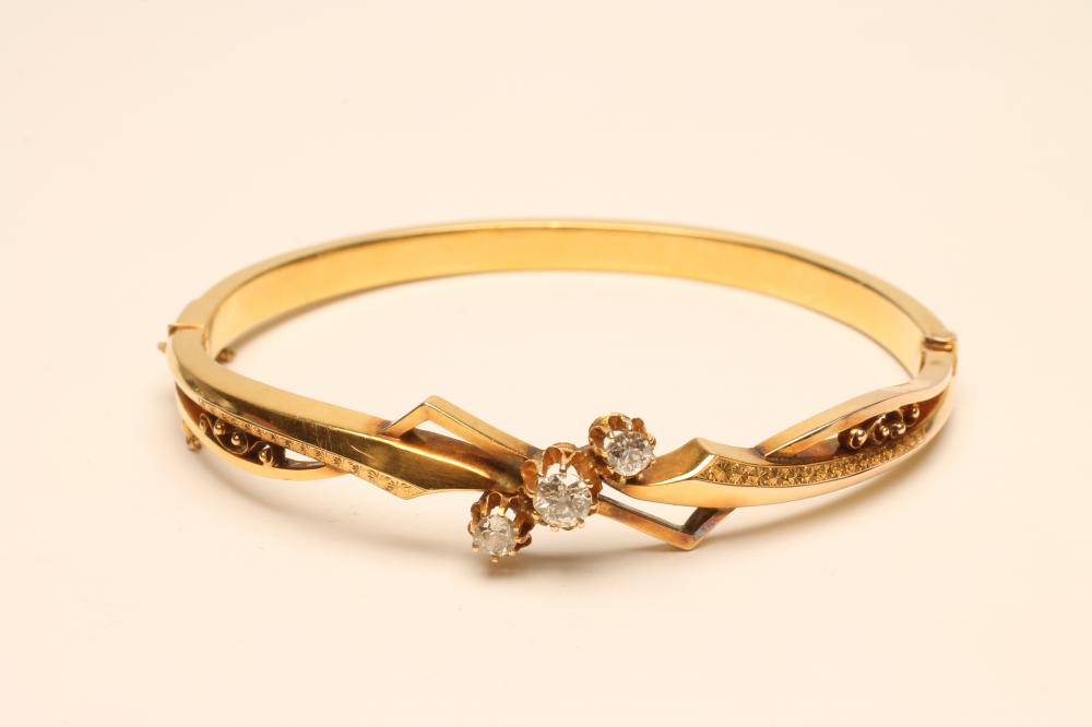 A VICTORIAN GOLD STIFF HINGED BANGLE Image