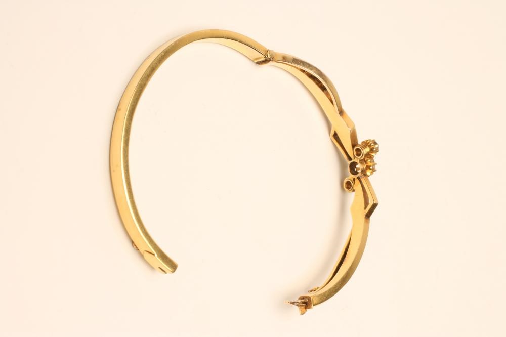 A VICTORIAN GOLD STIFF HINGED BANGLE Image