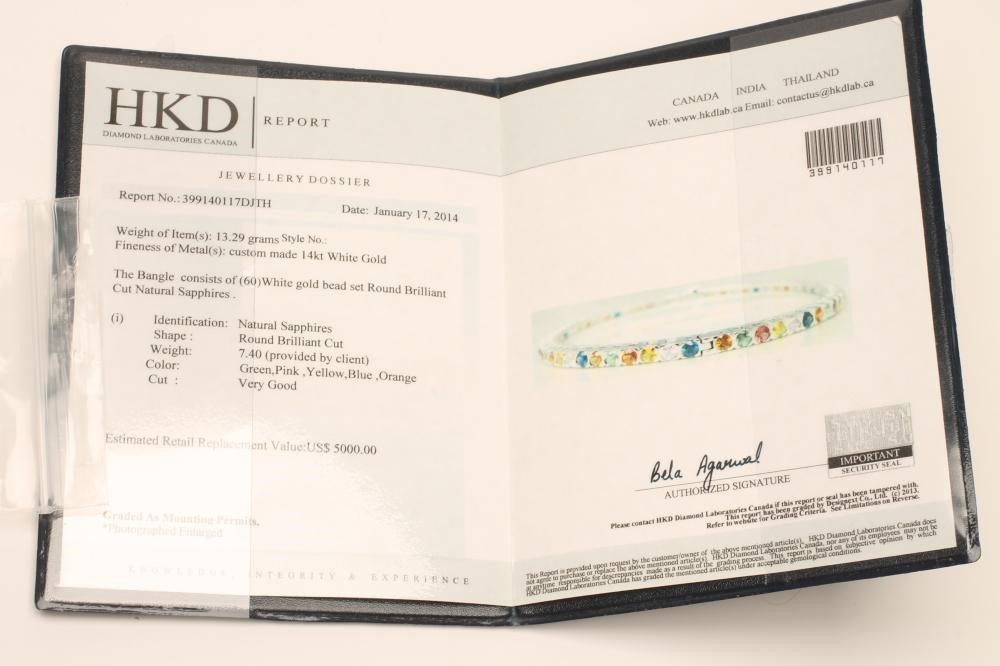 A MULTI-COLOURED SAPPHIRE STIFF HINGED BANGLE Image