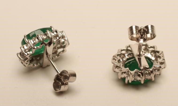 A PAIR OF EMERALD AND DIAMOND CLUSTER EAR STUDS Image