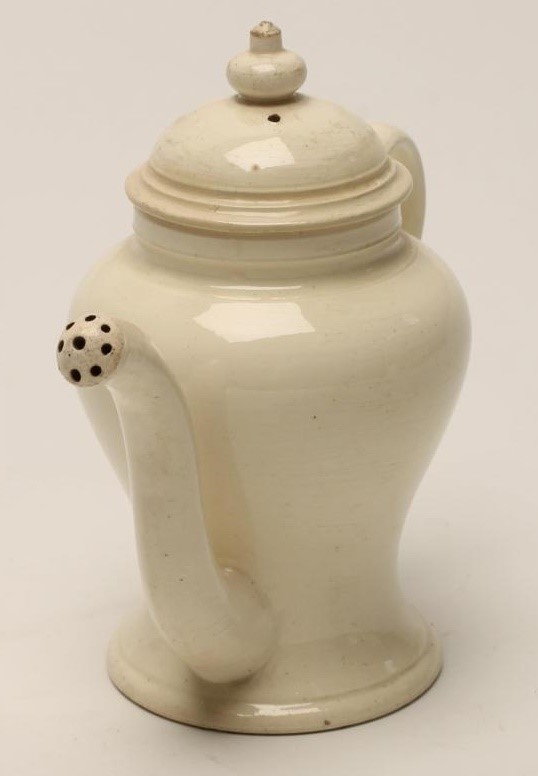 A CREAMWARE ROSEWATER SPRINKLER AND COVER Image