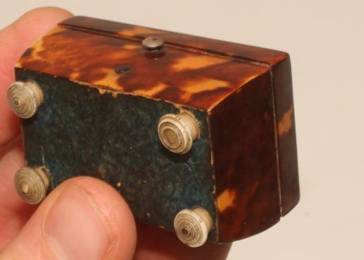 A REGENCY TORTOISESHELL SMALL TEA CADDY of sarcophagus form strung in white metal Image