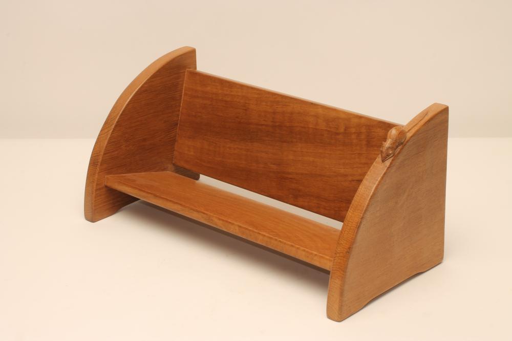 A ROBERT THOMPSON ADZED OAK BOOK TROUGH of oblong form with crescent shaped ends on bracket feet Image