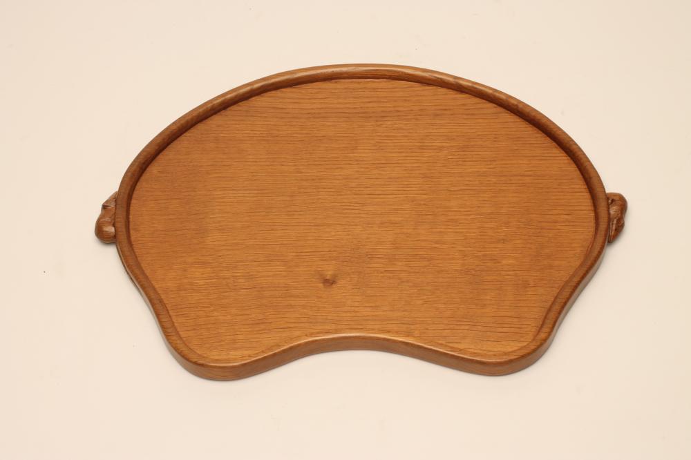 A ROBERT THOMPSON ADZED OAK TRAY of kidney form with two carved mouse trademark lug handles Image