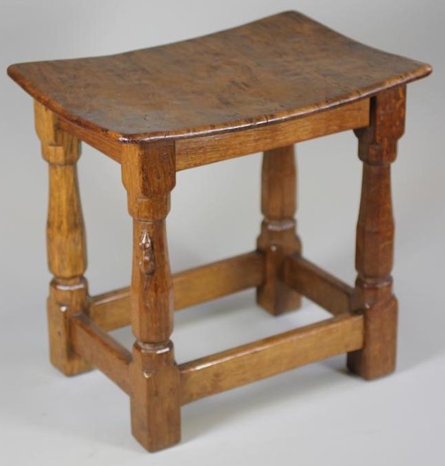 A ROBERT THOMPSON ADZED OAK STOOL of rounded oblong form Image