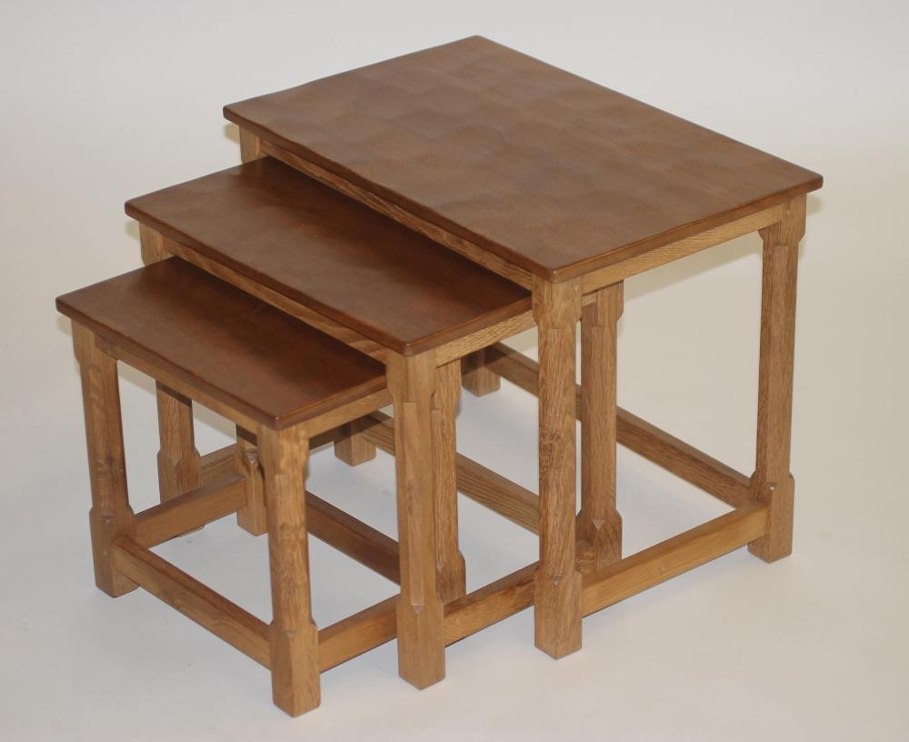 A ROBERT THOMPSON ADZED OAK NEST OF TABLES of oblong form Image