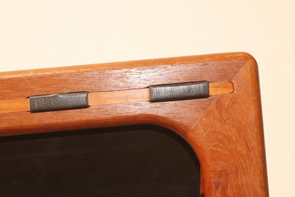 A TEAK AND BROWN LEATHER MAGAZINE RACK of open frame oblong form with central division Image