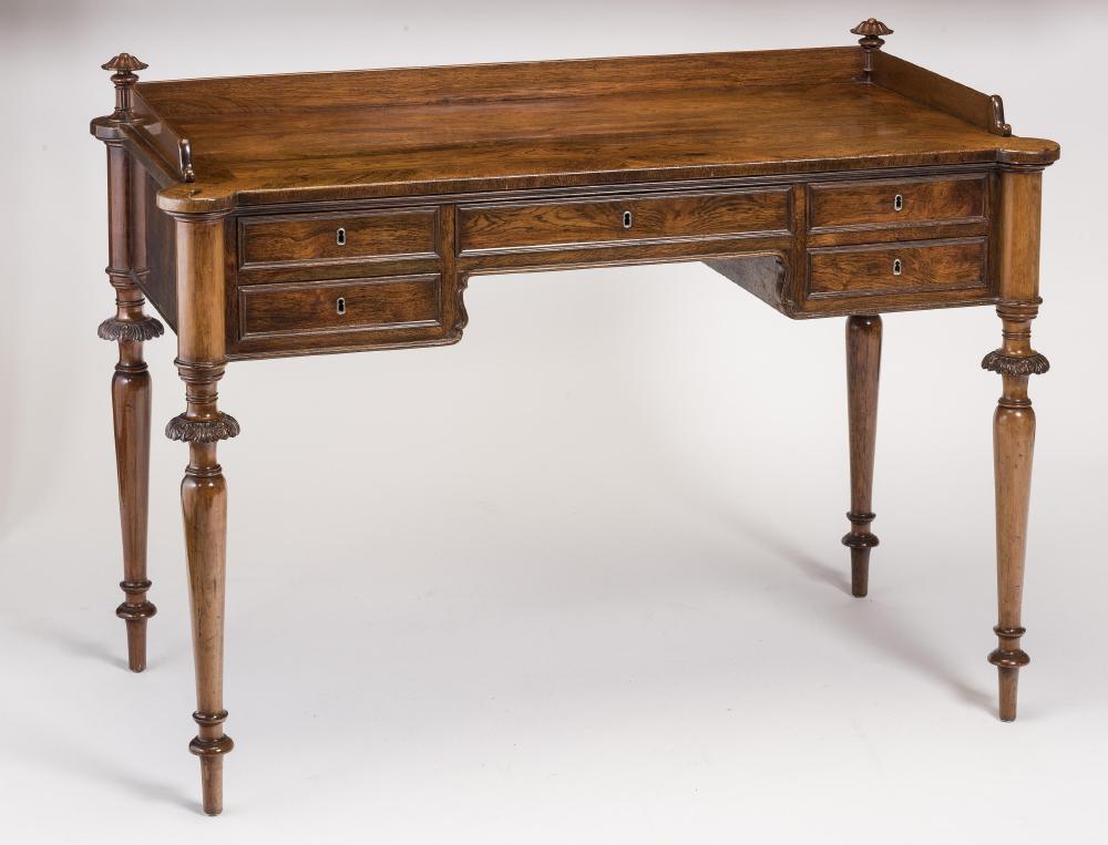 A NAPOLEON III ROSEWOOD WRITING TABLE of oblong form with protruding corners on turned tapering Image