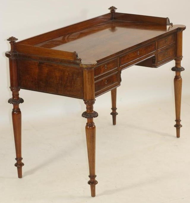 A NAPOLEON III ROSEWOOD WRITING TABLE of oblong form with protruding corners on turned tapering Image