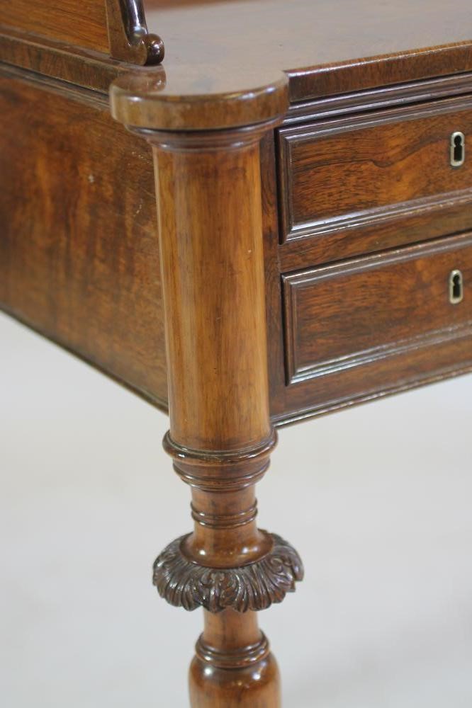 A NAPOLEON III ROSEWOOD WRITING TABLE of oblong form with protruding corners on turned tapering Image