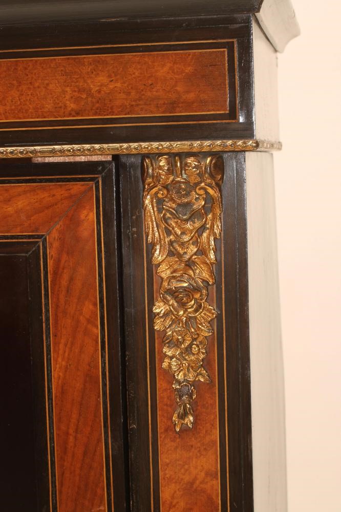A VICTORIAN EBONISED AND WALNUT PIER DISPLAY CABINET with inlaid roundels and gilt metal mounts Image