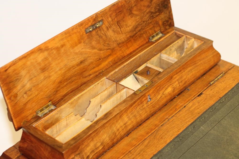 A VICTORIAN WALNUT DAVENPORT Image