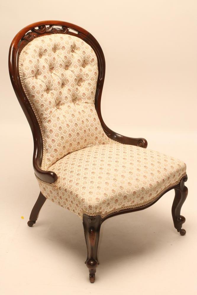 A VICTORIAN WALNUT FRAMED NURSING CHAIR of spoonback form button upholstered in a floral ivory weave Image