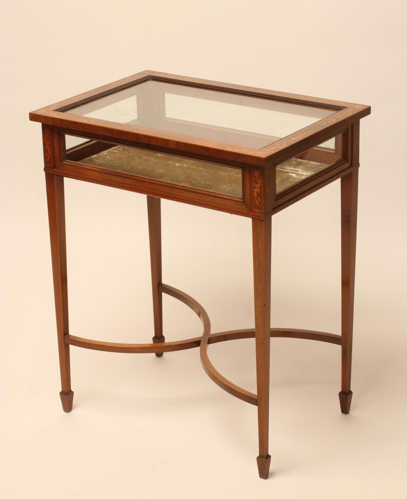 AN EDWARDIAN MAHOGANY BIJOUTERIE TABLE of oblong form with stringing and marquetry trailing foliage Image