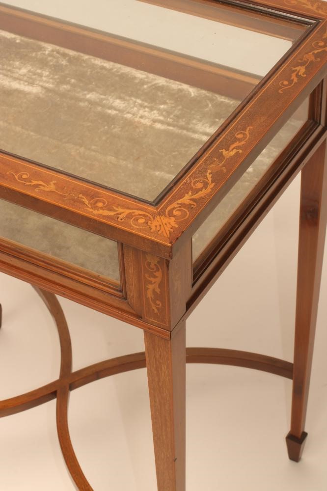 AN EDWARDIAN MAHOGANY BIJOUTERIE TABLE of oblong form with stringing and marquetry trailing foliage Image