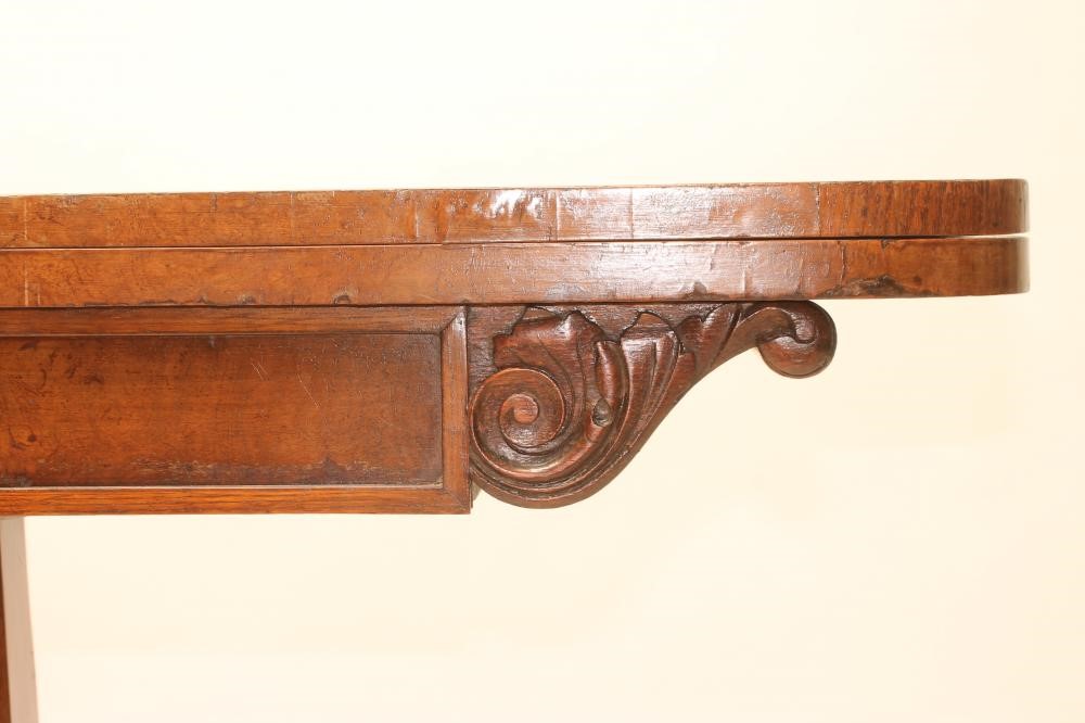 AN EARLY VICTORIAN POLLARD OAK FOLDING CARD TABLE of rounded oblong form Image