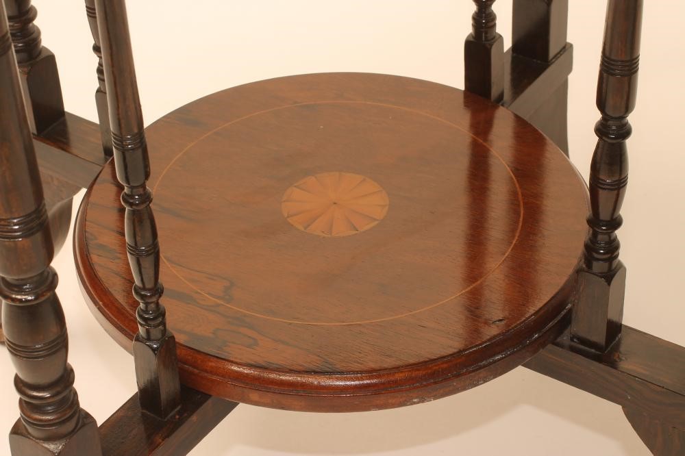 A VICTORIAN ROSEWOOD OCCASIONAL TABLE of circular form with stringing and marquetry batwing roundels Image