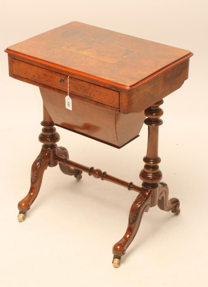 A VICTORIAN WALNUT PILLAR END WORK TABLE of rounded oblong form Image