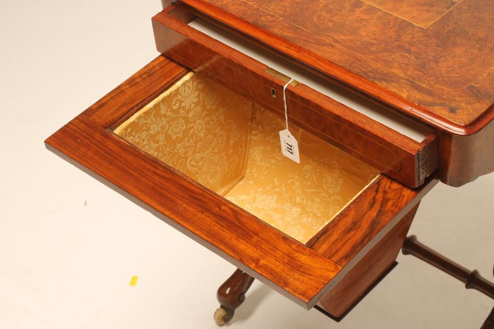 A VICTORIAN WALNUT PILLAR END WORK TABLE of rounded oblong form Image