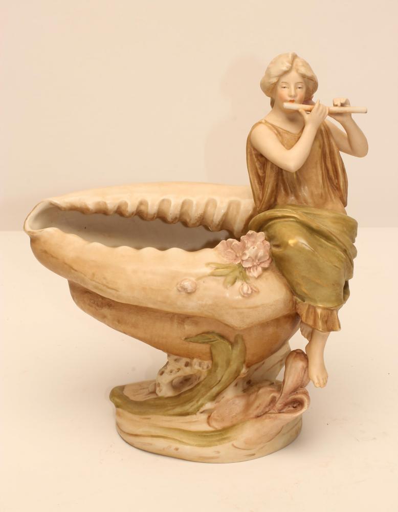 AN ART NOUVEAU ROYAL DUX BISQUE PORCELAIN FIGURAL CENTREPIECE modelled as a maiden playing a flute Image